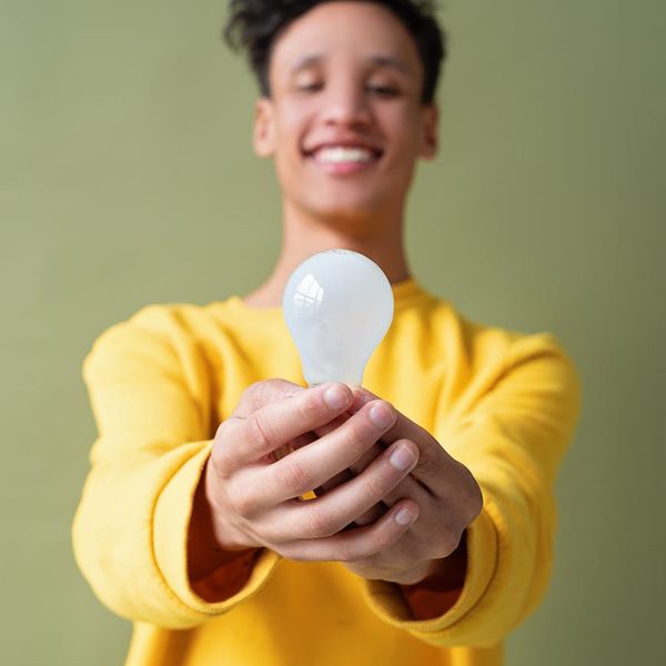 Man holding a plank position with perfect form in a bright studio.